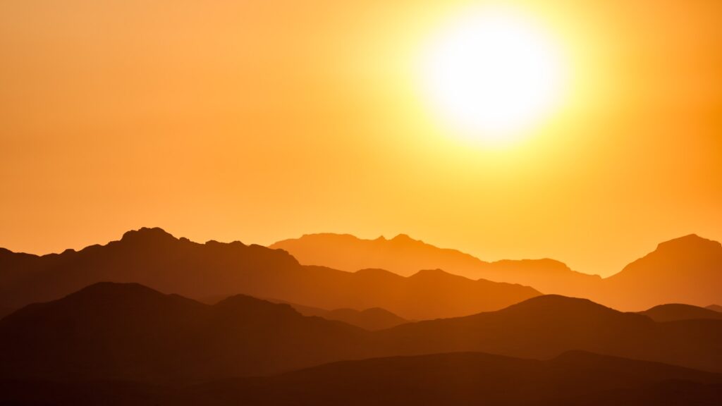 Sun shining over mountains