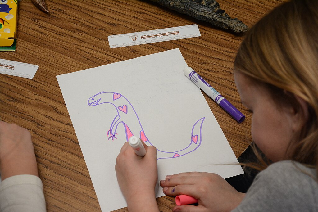 elementary students draw the dinosaur