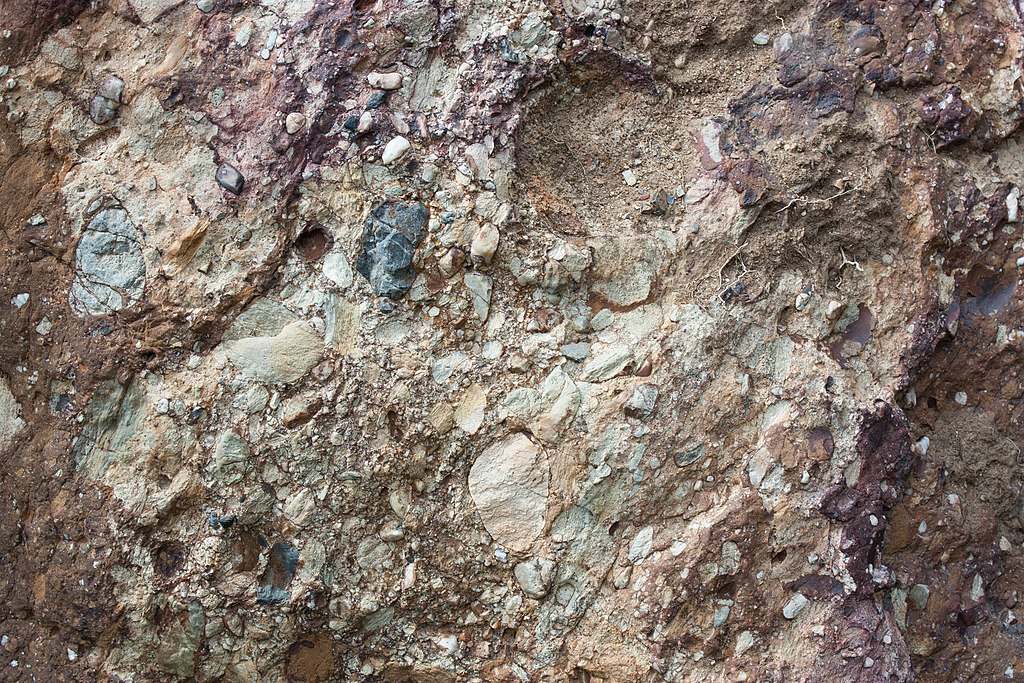 Permian sandstone with tillite deposits in Werribee Gorge, Victoria, reveals the powerful movement of a continental ice sheet 250–290 million years ago, leaving behind a mix of mud, stones, and boulders