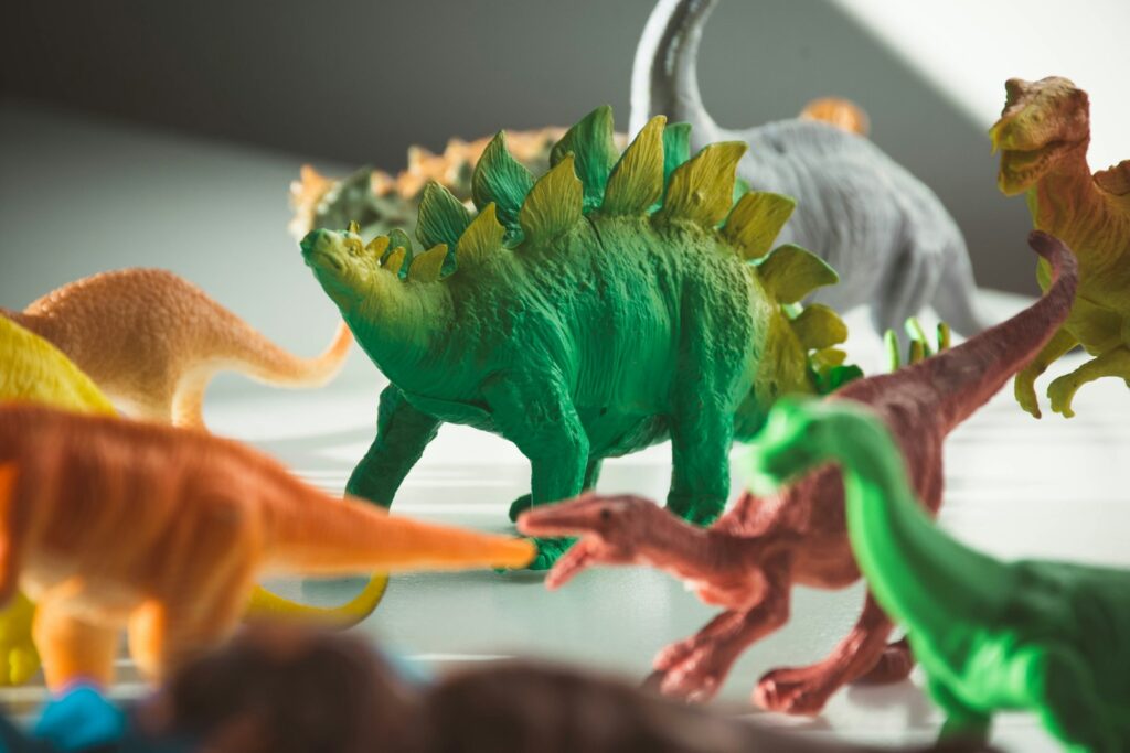 green and orange dinosaur plastic toy