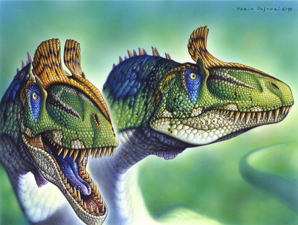 Two vibrant dinosaurs with scaly green and blue skin face the viewer. Their textured frills and sharp teeth create a dynamic, prehistoric scene.