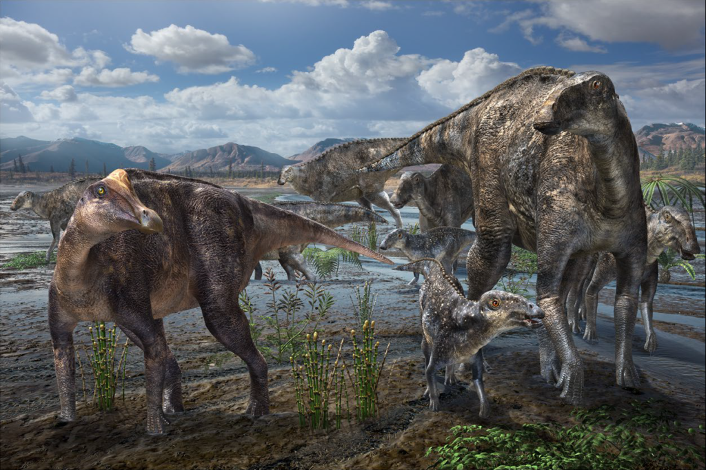 A herd of dinosaurs, including adults and juveniles, wander near a wetland with mountains in the background. The setting is prehistoric, under a bright sky.