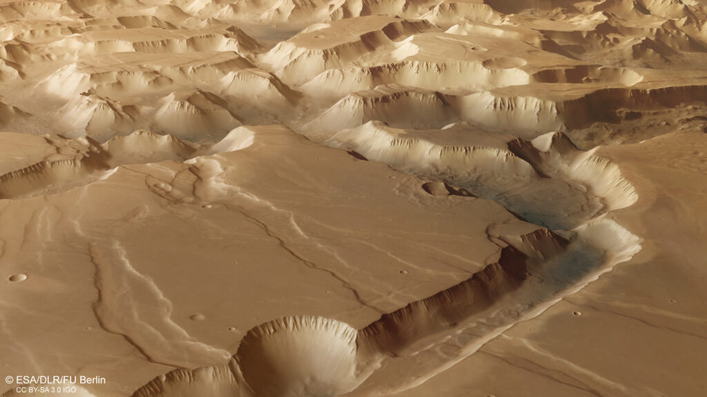 Aerial view of Mars’ Valles Marineris canyon, with steep, rugged cliffs and deep valleys. The reddish terrain conveys a majestic, desolate atmosphere.