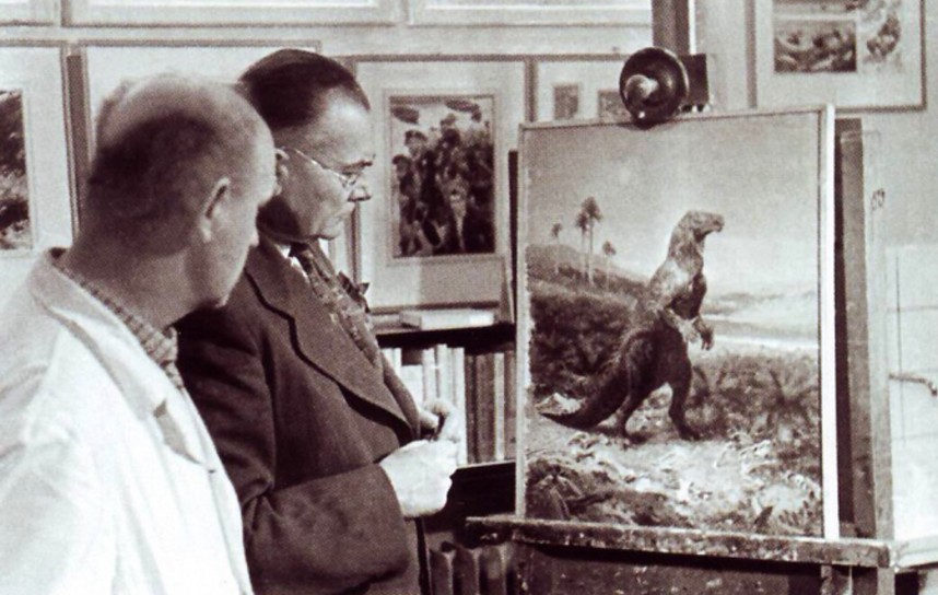 Painter Zdeněk Burian (left) and palaeontologist Josef Augusta (right), with Burian's then recently finished painting of an Iguanodon (1950)