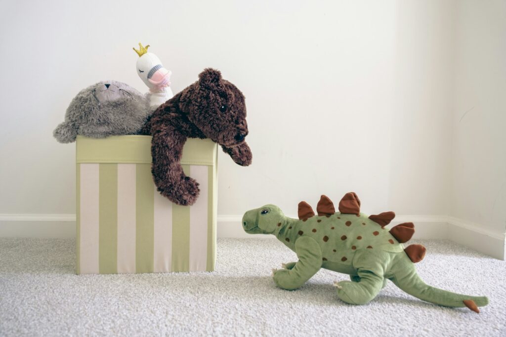 green dinosaur toy on a light carpeted floor