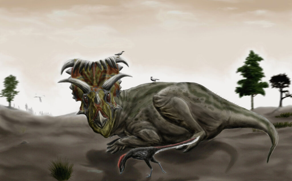 A large horned dinosaur with a colorful frill, resembling a Kosmoceratops, is accompanied by small birds on its back and a smaller dinosaur nearby. Trees and a hazy sky provide a natural setting.