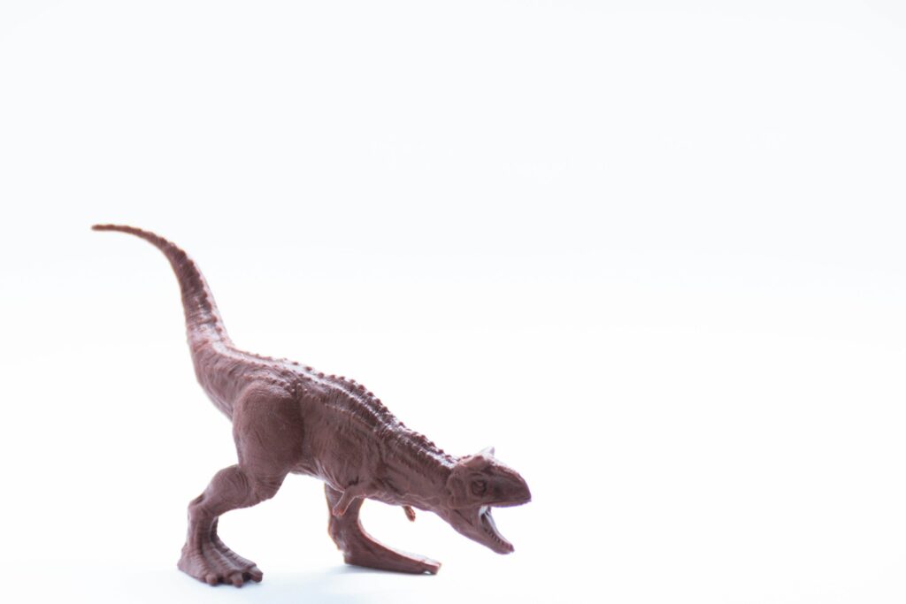 gray dinosaur toy on white background
