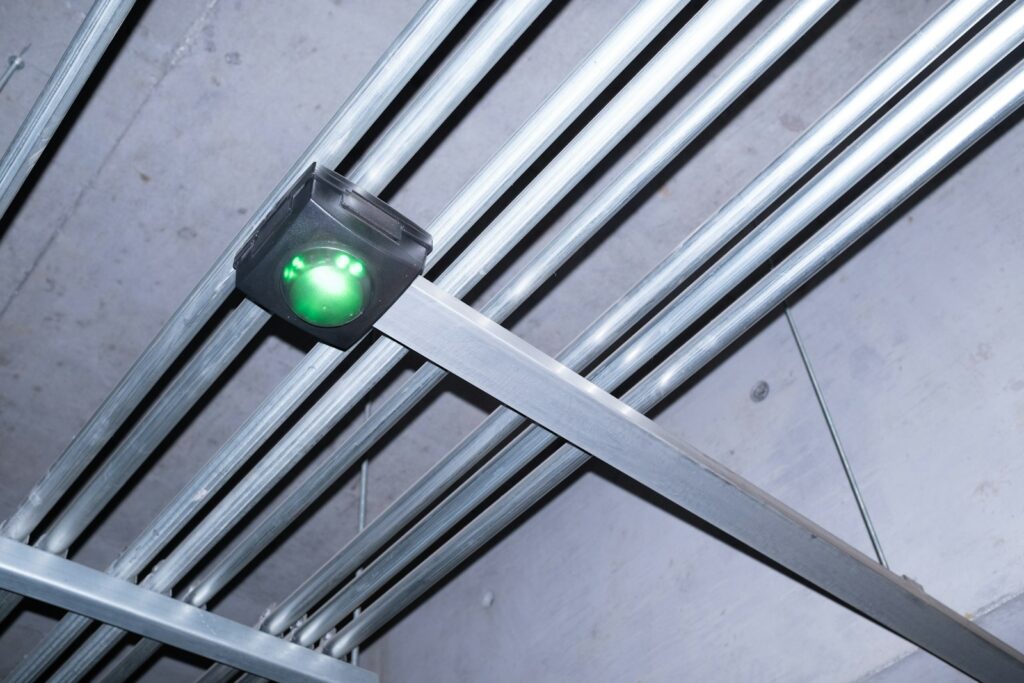 Electrical wiring and light fixtures are mounted on the ceiling.