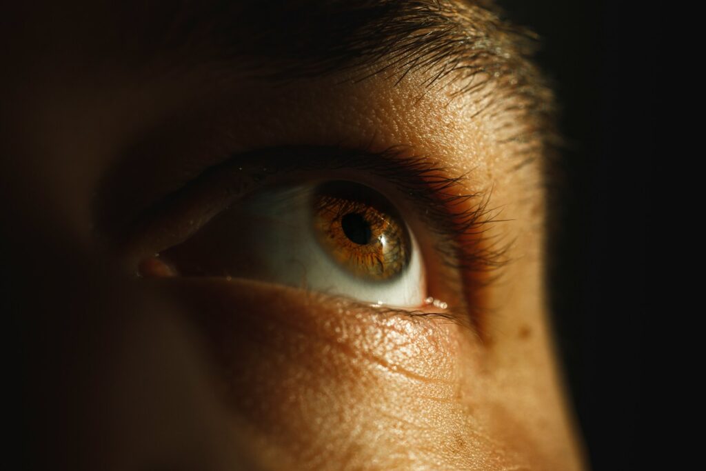 A close up of a person's eye with a blurry background
