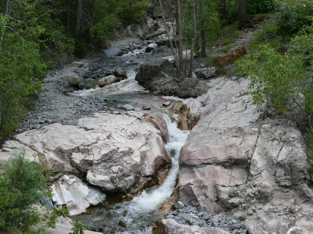 A stream of water running down a rocky hillside