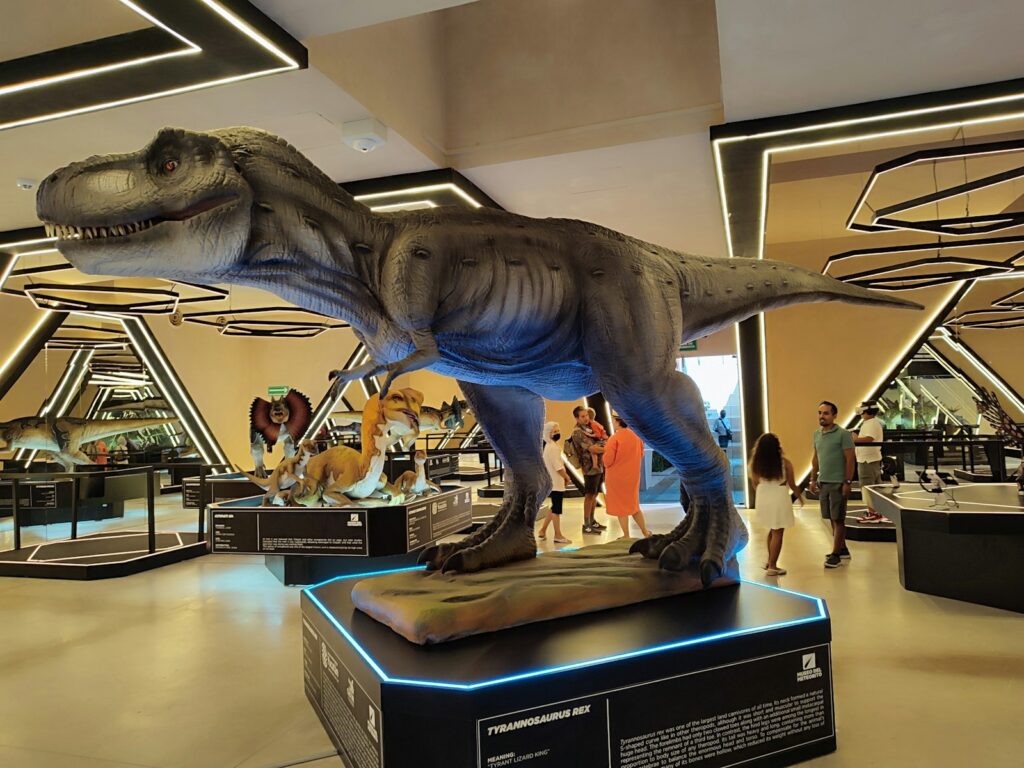 a dinosaur statue on a stand
