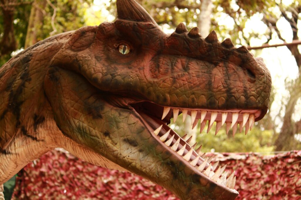 A close up of a dinosaur with its mouth open