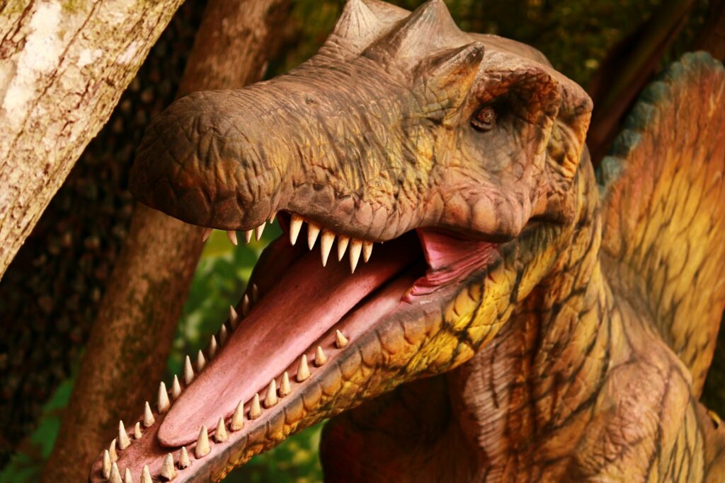 A close up of a dinosaur with its mouth open