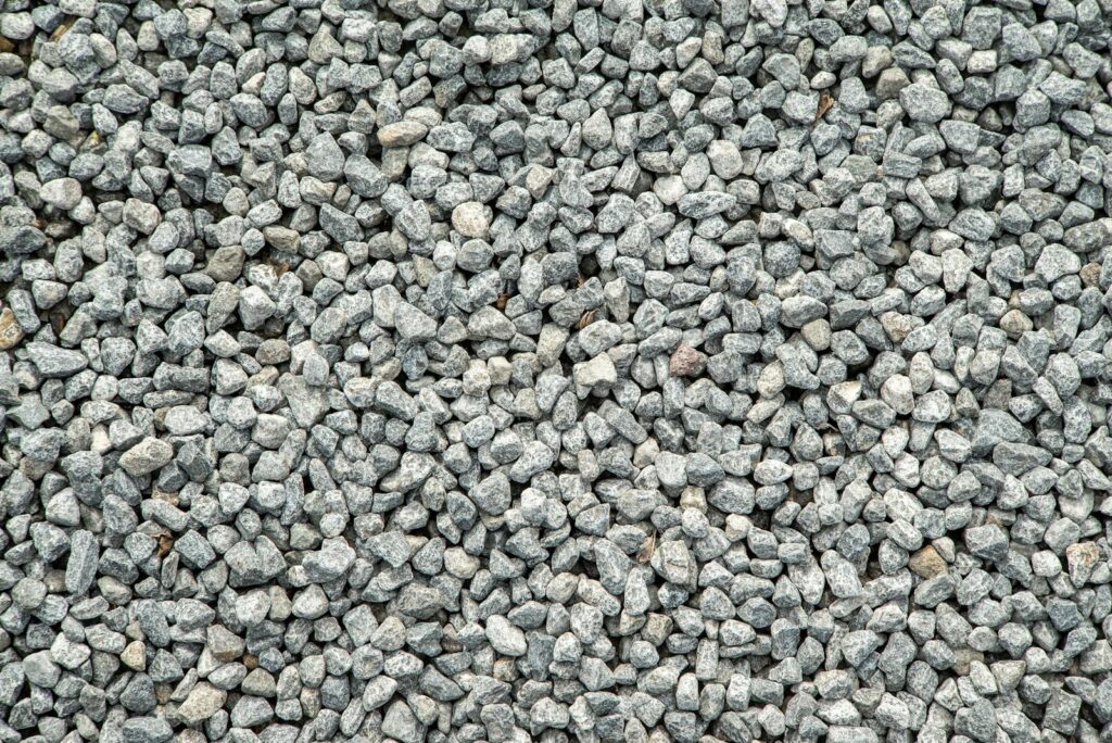 Detailed view of grey gravel stones creating a textured pattern for background use.