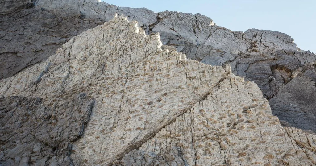 A Tropical Lagoon Becomes a Vertical Alpine Cliff
